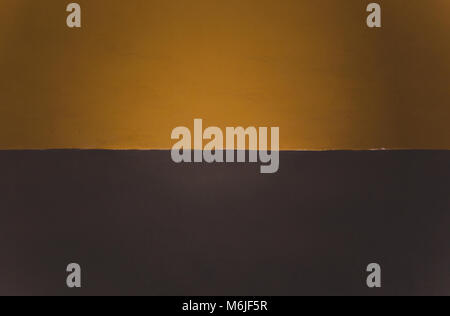 Two-toned split mustard yellow/orange and brown painted background with space for copy Stock Photo