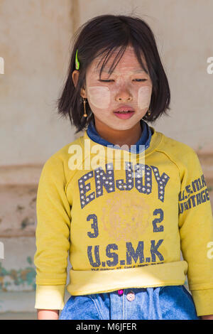 Young girl with thanaka on cheeks at Shwezigon Pagoda, Nyaung U, Bagan, Myanmar (Burma), Asia in February Stock Photo