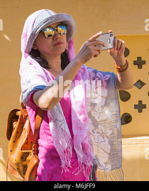 Visitor taking photos with reflections in sunglasses at Shwezigon Pagoda, Nyaung U, Bagan, Myanmar (Burma), Asia in February Stock Photo