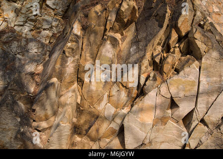 texture of brown ruffled old rocks by day Stock Photo