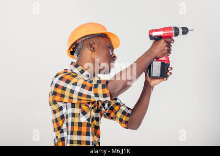 African American worker uses electric screwdriver Stock Photo
