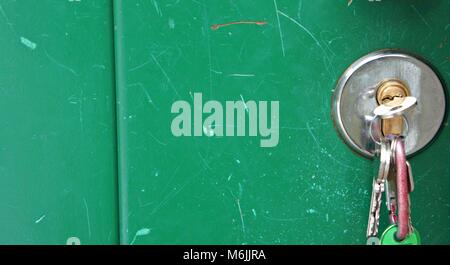 keys in the door green background Stock Photo