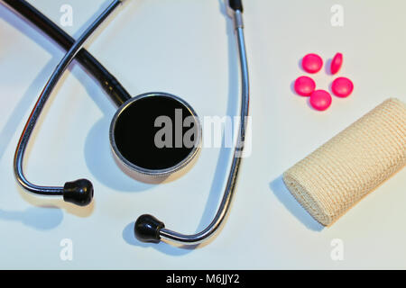 Stethoscope, pill and bandage on white background, medical concept Stock Photo