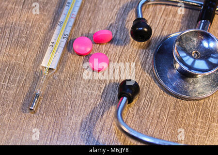 Stethoscope, pill and thermometer close up, medical concept Stock Photo