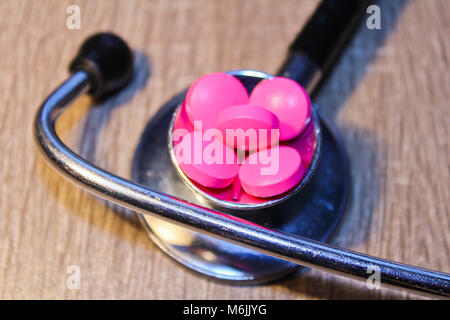 Pills in stethoscope from close up, medical concept Stock Photo