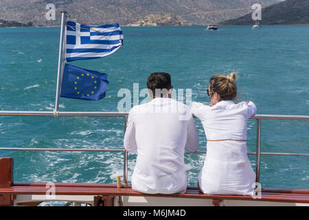 Couple on back of excursion boat returning from Spinalonga, Elounda, Lasithi Region, Crete (Kriti), Greece Stock Photo