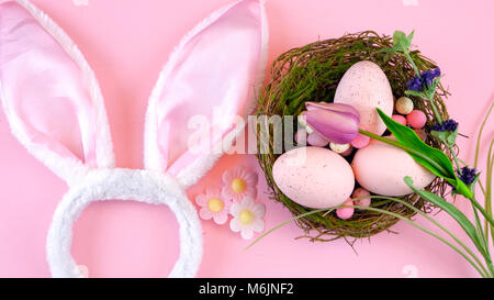 Happy Easter overhead with Easter eggs and decorations on a wood table background Stock Photo