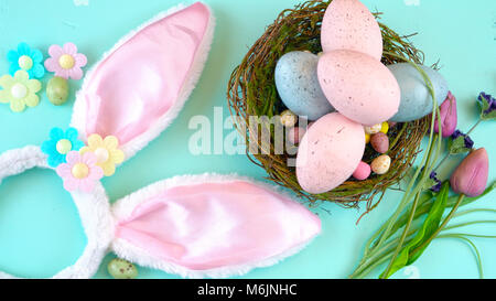 Happy Easter overhead with Easter eggs and decorations on a wood table background Stock Photo