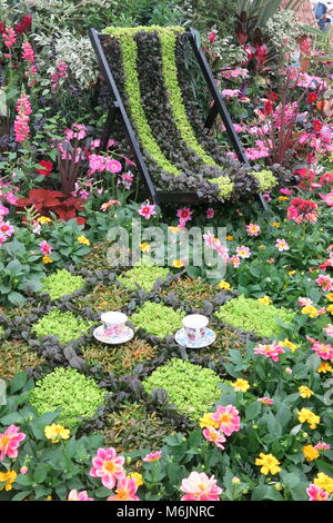 Time for tea - take a rest in this show garden where everything is made from flowers and plants, including the deckchair and the patio Stock Photo