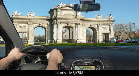 Driving a car towards Alcala Gate (Puerta de Alcala), iconic landmark in Madrid, Spain Stock Photo