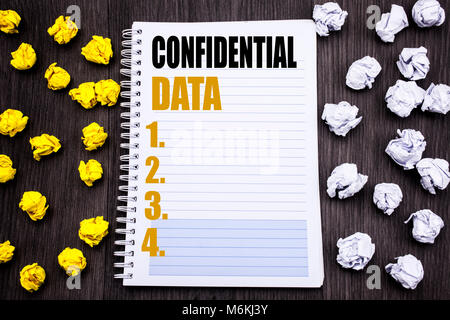 Conceptual hand writing text caption showing Confidential Data. Business concept for Secret Protection Written notepad note notebook book wooden backg Stock Photo