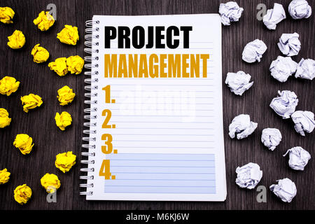 Conceptual hand writing text caption showing Project Management. Business concept for Strategy Plan Goals Written notepad note notebook book wooden ba Stock Photo