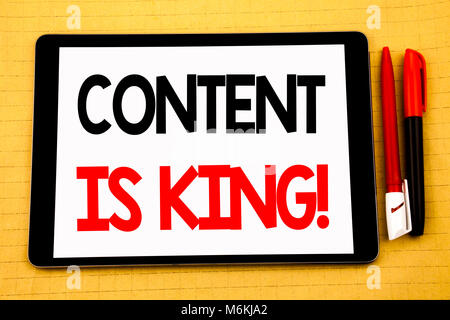Conceptual handwriting text caption inspiration showing Content Is King. Business concept for Online Internet Data Written on tablet, wooden backgroun Stock Photo