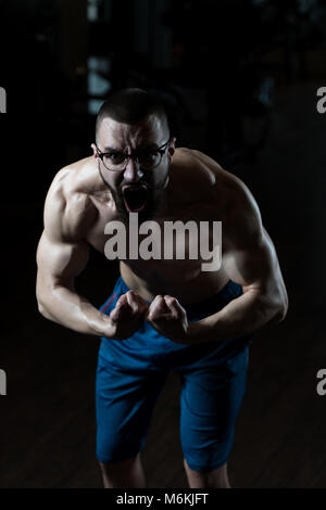 Portrait Of A Young Physically Fit Nerd Man Showing His Well Trained