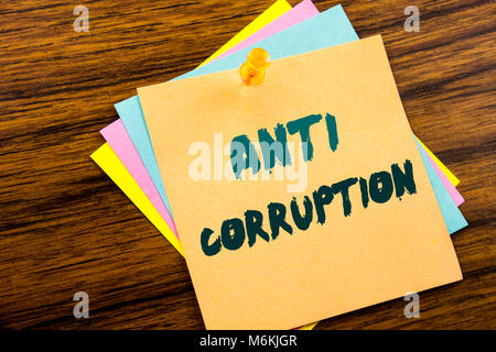 Hand writing text caption inspiration showing Anti Corruption. Business concept for Bribery Corrupt Text written on sticky note paper on wooden backgr Stock Photo