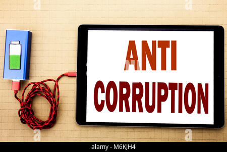 Hand writing text caption inspiration showing Anti Corruption. Business concept for Bribery Corrupt Text written on tablet laptop with white textured  Stock Photo
