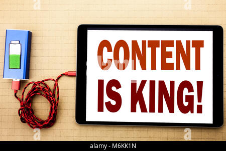 Hand writing text caption inspiration showing Content Is King. Business concept for Online Internet Data written on tablet laptop with white textured  Stock Photo
