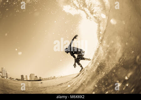Surfing surfer silhouetted water action photo unidentified closeup in vintage sepia Stock Photo