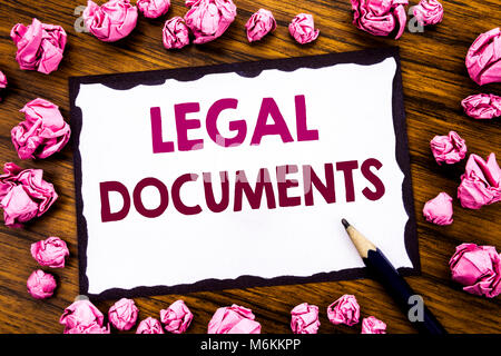 Hand writing text caption inspiration showing Legal Documents. Business concept for Contract Document Written on sticky note paper, wooden background  Stock Photo
