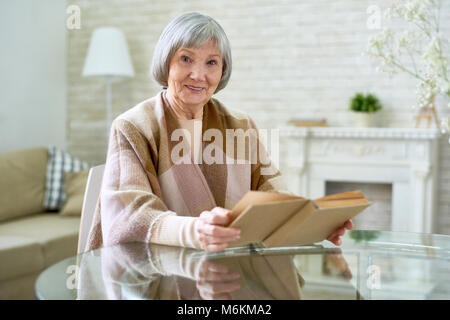 Elegant Senior Lady Reading Book Stock Photo