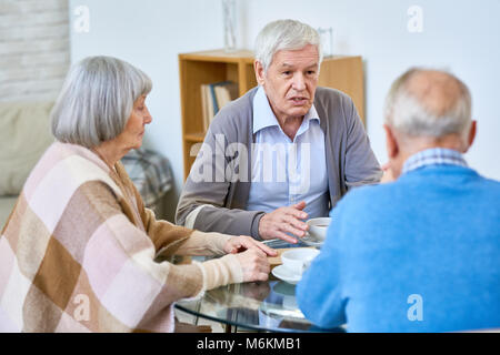 Senior Man Talking to Friends Stock Photo