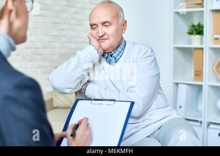 Depressed Senior Man in Therapy Stock Photo