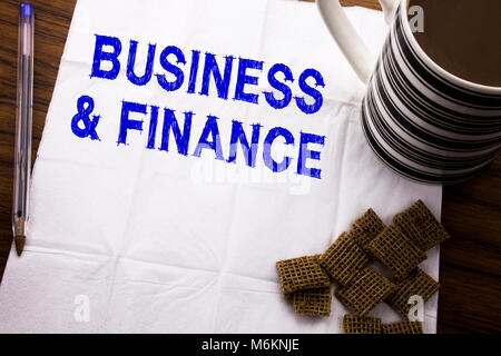 Hand writing text caption showing Business And Finance. Business concept for Company Strategy written on tissue paper on wooden background with pen an Stock Photo