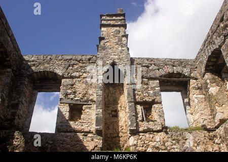 Looking at the sky through the interior of a ruined old stone house Stock Photo