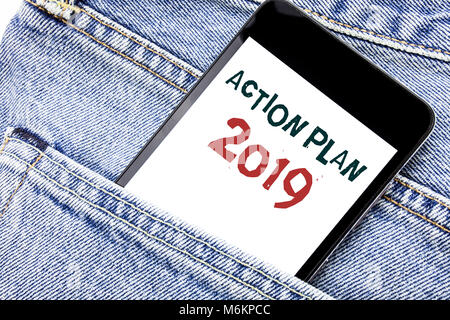 Handwriting Announcement text showing Action Plan 2019. Business concept for Success Strategy Written phone mobile phone, cellphone placed in man fron Stock Photo