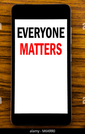 Handwriting Announcement text showing Everyone Matters. Business concept for Equality Respect Written on mobile cellphone with wooden background with  Stock Photo