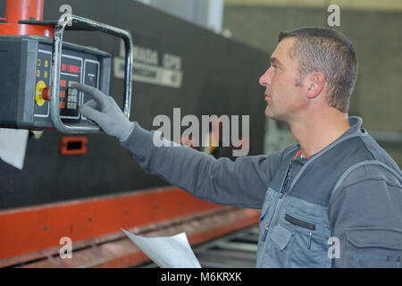 operating a machine Stock Photo