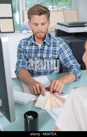 interior designer showing colour wheel to customer Stock Photo