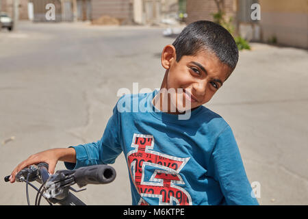 Kashan, Iran - April 27, 2017: A close-up portrait of an unknown Iranian boy, about 12 years old, who played outdoors. Stock Photo