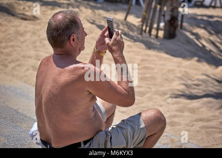 Man using smartphone to take a photograph Stock Photo