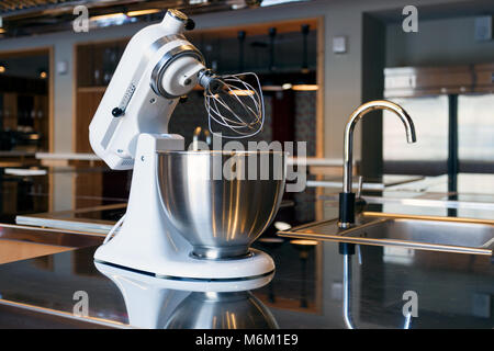 A beautiful white mixer with a metal cup stands in the modern kitchen Stock Photo