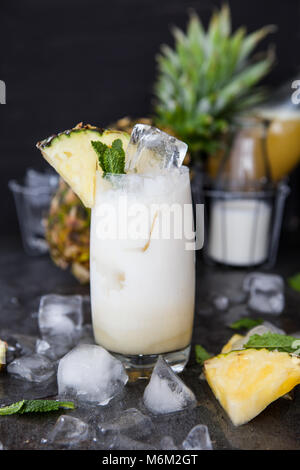 Tall glasss of Pina Colada Cocktail with fresh pineapple Stock Photo