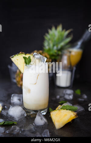 Tall glasss of Pina Colada Cocktail with fresh pineapple Stock Photo