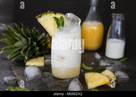 Tall glasss of Pina Colada Cocktail with fresh pineapple Stock Photo