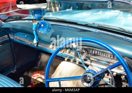 elvis doll and furry dice hanging from mirror of classic ford falcon Stock Photo