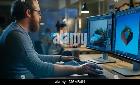 Creative Male Game Developer Works with Graphics for the New Level Design, He Sits at His Wooden Table Working on Two Display Personal Computer. Stock Photo