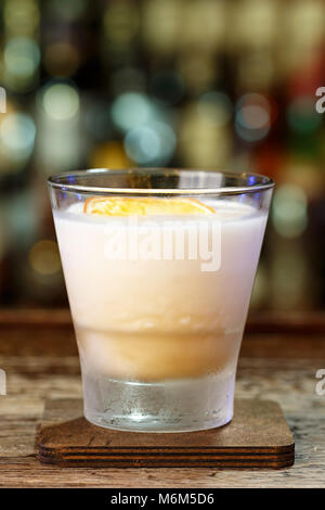 Refreshing cocktail whiskey sour on the bar in a restaurant or pub, space for text design Stock Photo