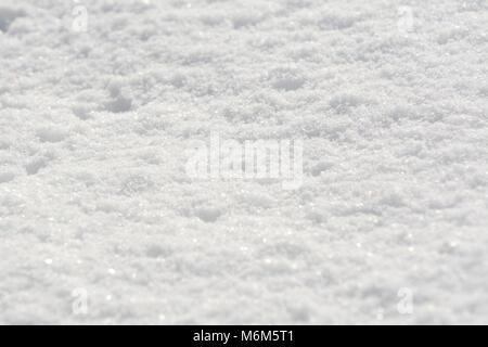 Fluffy fresh white snow sparkling in sunlight, as an abstract winter background Stock Photo