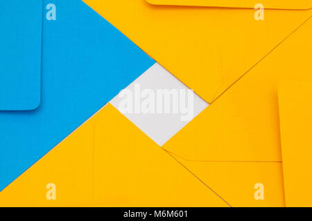Pattern from blue and yellow envelopes on the white table Stock Photo