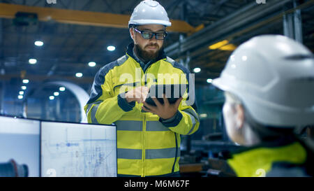 Inside the Heavy Industry Factory Female Industrial Engineer Works on Personal Computer She Designs 3D Engine Model Her Male Boss Uses Tablet Computer Stock Photo