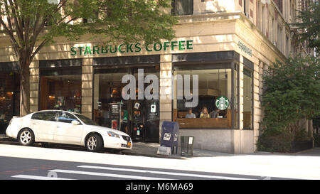 New York City - August 14 2016: Starbucks coffee retail location on upper east side Manhattan. People visit in morning for daily caffeine intake and e Stock Photo