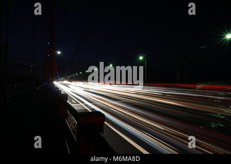 Light trail - busy commuter traffic driving over the George Washington Bridge between New Jersey and Manhattan New York City in the evening. Night tim Stock Photo
