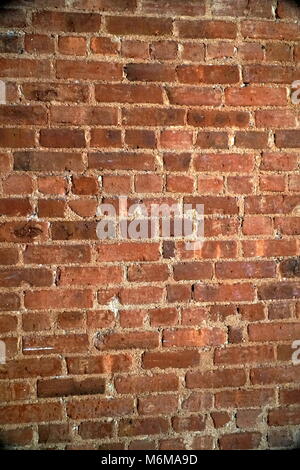 Red brick wall pattern. Interior construction design creates modern urban feel for home living. Vertical framing Stock Photo