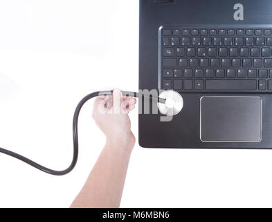 hand with stethoscope on laptop computer Stock Photo