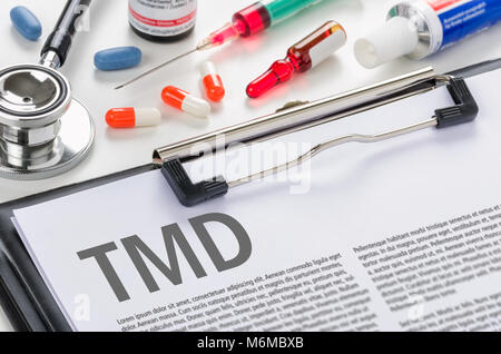 The diagnosis TMD written on a clipboard Stock Photo