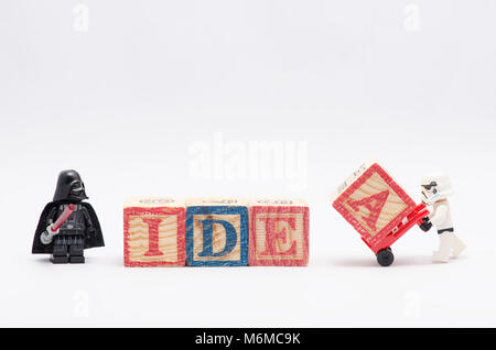 lego darth vader watching storm trooper assembling word idea using colorful alphabets block. isolated on white abckground. Stock Photo